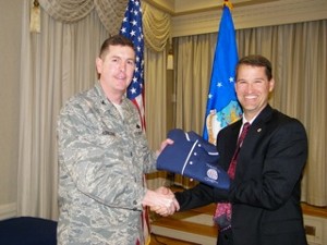 Bill Marion (r), chapter president, presents Col. Donald Kirkland, USAF, commander, 633rd Air Base Wing, Langley Air Force Base, with a chapter polo shirt following the colonel's speech at the February meeting.