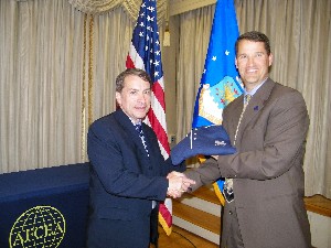 Bill Marion (r), chapter president, presents Frank Konieczny, chief technology officer, Office of Information Dominance and Chief Information Officer, Office of the Secretary of the Air Force, with a chapter polo shirt following his speech at the March meeting.