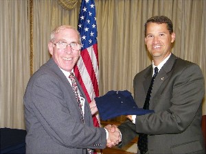 Bill Marion (r), chapter president, presents Allan Resnick, director, Assessment, Architecture and Battle Command, Army Capabilities Integration Center, U.S. Army Training and Doctrine Command, Fort Monroe, Virginia, with a chapter shirt following his speech in September.