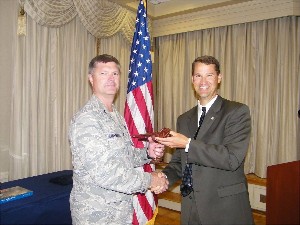 Marion (r) recognizes Col. David Hunninghake, USAF, chapter vice president, as the AFCEAN of the Month for September. He also received a farewell gift for his dedication and commitment to AFCEA.