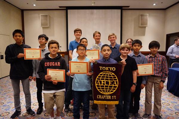 Winners of the Kanto Plains Robot Rumble receive scholarships and certificates from the chapter at an April meeting.