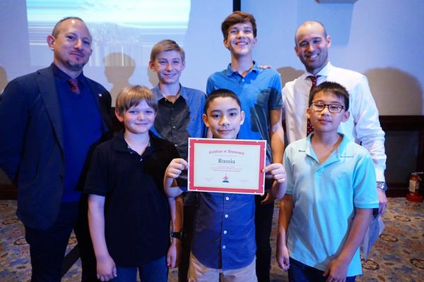 Chapter President Scott Jarkoff (l) and Chapter Executive Vice President Tohru Okamura (r) present a certificate to Soccer World Cup Team Russia at the April meeting.