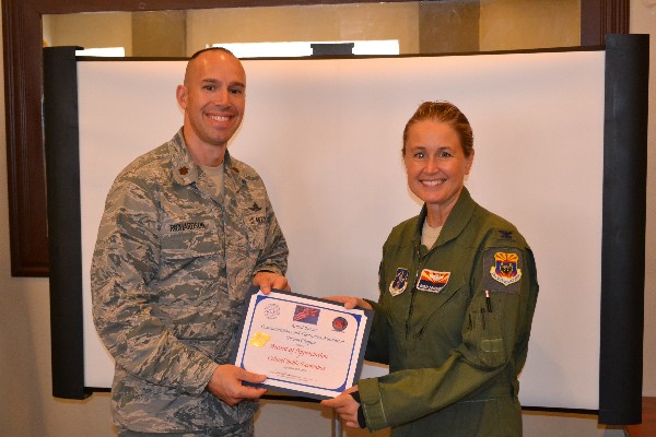 Chapter President Maj. Chad Richardson, USAF presents a certificate of appreciation to Col. Bobbi Doorenbos, USAF, commander of the 214th Reconnaissance Group, following her address to the Chapter on MQ-1 Predator operations and reliance on a distributed communications architecture in September.