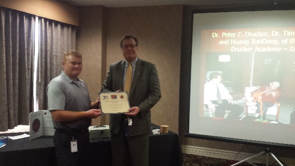 Maj. Jason Carlson, USAF (Ret.) (l) presenting Dr. Timothy Dosemagen, director, ITT Technical Institute, with a certificate of appreciation at the chapter's March luncheon.