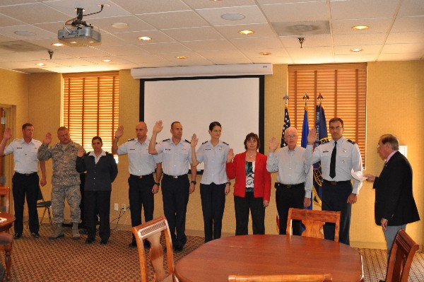 Larry Bingaman (far r), regional vice president, swears in the chapter's new board of directors in November, including (l-r) Master Sgt. Scott Nielsen, USAF, treasurer; Senior Master Sgt. Michael Patz, USAF, vice president, enlisted affairs; Capt. Tricia Pacheco, USAF, secretary; Capt. Dan Presland, USAF, vice president, Young AFCEANs; Maj. Chad Richardson, USAF, vice president, academic affairs; Capt. Stacie Voorhees, USAF, vice president, programs; Geri Smith, vice president, membership; Tom Flannery, vice president; and Col. Richard Palmieri, USAF, president.