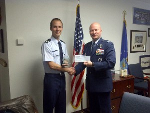 Cadet Roger S. Anderson, Air Force ROTC (l), Detachment 020, receives the chapter's Leadership in Technology Award in December from Col. Wade J. Thompson, USAF, professor of aerospace studies, Detachment 010, University of Arizona.