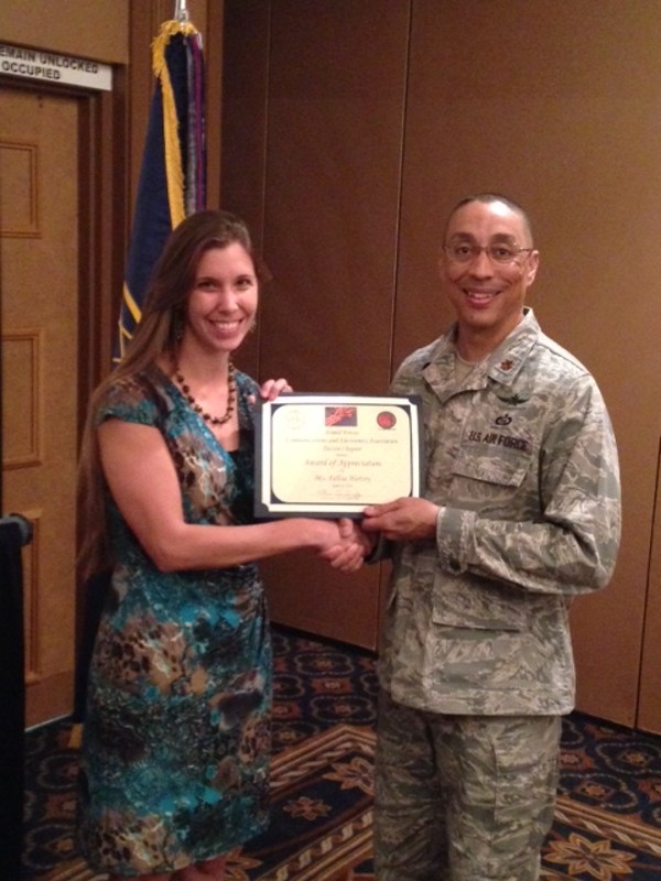 Maj. Brian Sroufe, USAF, chapter president, presents a certificate of appreciation to Felisa Hervey, president of Civil Vision International during the April chapter luncheon. She discussed how communication influences counterinsurgency operations based on her extensive deployment and volunteer time in Afghanistan.
