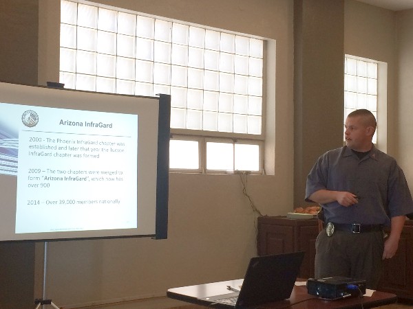 Elijah Woodward, an officer with the Oro Valley Police Department and a certified ethical hacker, provides some history on the inception of InfraGard at the September luncheon.
