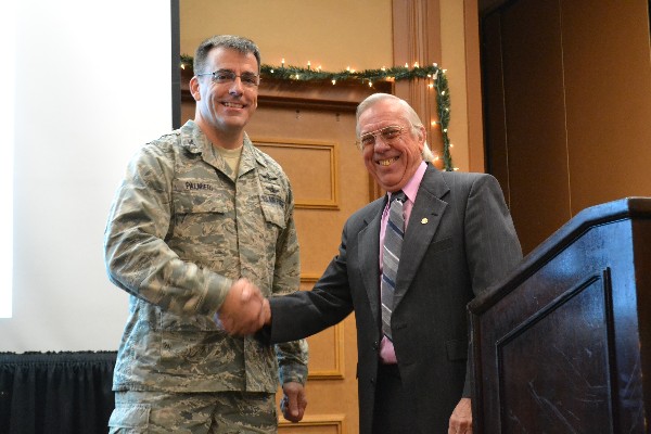 Larry Bingaman (r), regional vice president, presents the AFCEA coin for Outstanding Service to Col. Dick Palmieri, USAF, for his dedication in developing Young AFCEANs. The chapter has both a chapter and regional distinguished Young AFCEAN this year for the first time in its history.