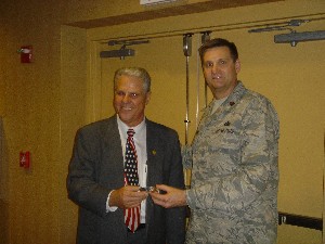 Maj. Kevin Rook, USAF (r), chapter president, presents a token of appreciation to guest speaker Thomas Shambo, a business analyst at the Pima County Small Business Development Center. Shambo spoke at the August meeting.
