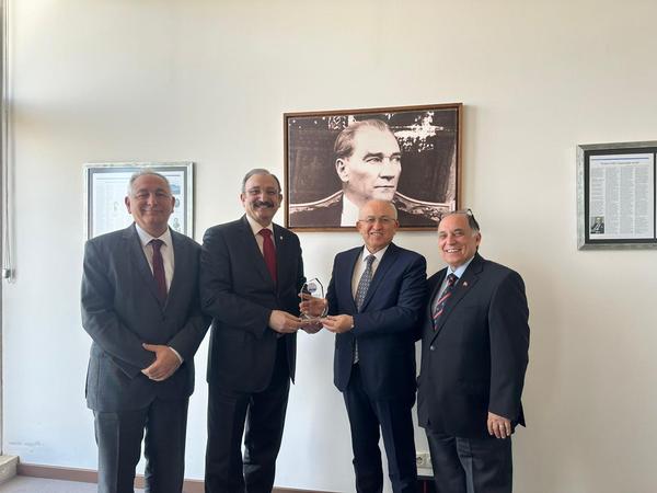 In March, Chapter President Kamil Zafer Selcuk presents Meteksan Defense Inc.'s Deputy General Manager Erdal Torun with a token of his visit.