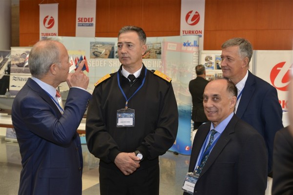 Rear Adm. H. Nihat Dogan, (c) TUN, chief of logistic department of TNC., talks with some of the participants at the exhibition hall of the seminar in October. Looking at the camera is Capt. A. Zafer Betoner, TUN (Ret.), chapter vice president.