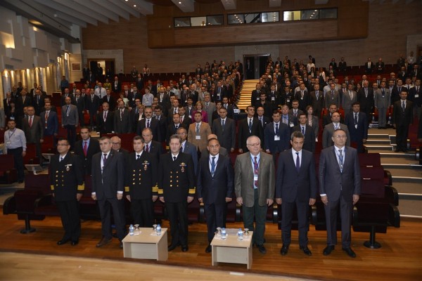 (4th f-l front row) Rear Adm. O. Mesut Ak, TUN, chief of technical division of Turkish Naval Command, (5th f-l) Mujdat Uludag, head of Naval platforms, Department of SSM, (3rd f-l) Capt. Mustafa Murat, TUN, chief of ship building division of TNC, (6th f-l) Dr. Kemal Leblebicioglu, instructor, METU-EEE, (8th f-l) Mustafa Kaval, vice president of ASELSAN and the other participants stand for the National Anthem of Turkish Republic during the opening ceremony of the seminar in October.
