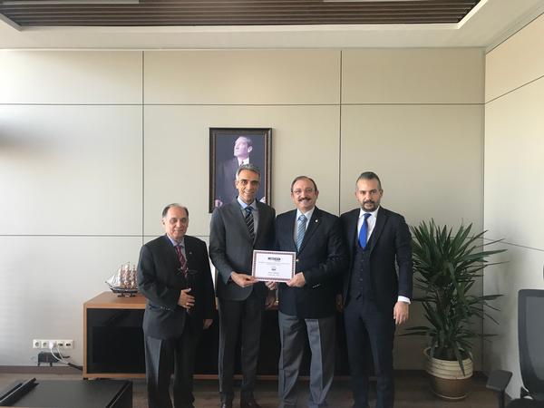 In February, Chapter President Kamil Zafer Selcuk (center r) presents a certificate of appreciation to Selcuk Kerem Alparsan, general manager of Turkish defense technology company Meteksan Savunma (center l).