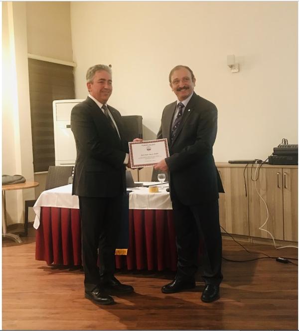 Chapter President Kamil Zafer Selcuk (r) presents certificate of appreciation to guest speaker Kadir Murat Bicer, cybersecurity manager, STM, at the February meeting.