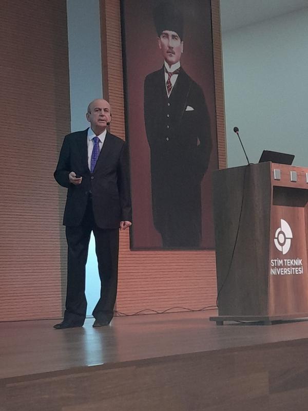 Nevzat Caglayan, consultant and educator, delivers his presentation at the October conference.