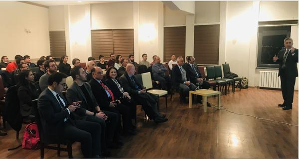 Audience members listen as Bicer presents on the future of cybersecurity at the February meeting.  