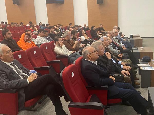 The audience listens to the conference speaker in October.