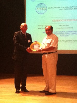 Serdar Erkoca, chief executive officer, Electronics Valley Limited, presents a plaque to Col. Buyukoner for his speech in September.