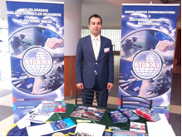 M. Yasar Ercan, chapter Young AFCEAN adviser and board member responsible for events and activities, oversees the chapter's exhibit in May.