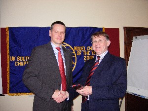 February guest speaker at UK Southern, Lt. Col. Chris Richards of the Defence Procurement Agency, receives a UK AFCEA tie from Col. Tom Moncur, chapter president, as a memento. He and the members then enjoyed a buffet and refreshments.