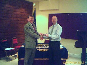 Steve Rodgers of Fortress Technologies (r), receives a chapter tie as a memento of appreciation from Col. Tom Moncur, British Army, chapter president.