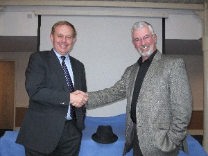 Russell Searle (l), chapter president, welcomes Air Cdre. Bruce Wynn, RAF (Ret.), to the September meeting on information systems security.