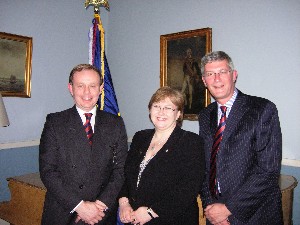 Jean McLeish, United Kingdom regional vice president, is flanked by guest speaker Brig. David Meyer, BA, (l), and Cmdr. Russell Searle, RN, at the March chapter meeting.