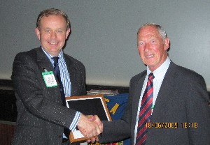 In June, Searle (l) recognizes Bill Kennedy, who is retiring from the chapter's committee after several years.