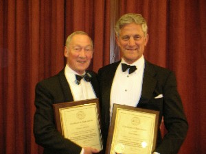 Col. Bill Kennedy, BA, and Cmdr. David Thomsett display plaques of appreciation awarded by the chapter in February for their years of dedicated service.  Both certificates were presented at the annual Chapter Ladies Night, held at the Royal Signals headquarters.