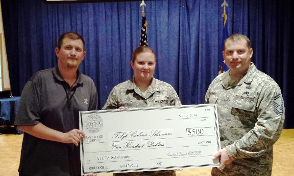 Nathan Simmons, chapter vice president, awards (l) and Senior Master Sgt. Patrick Hackman, USAF, chapter vice president, Young AFCEAN Affairs, present a science, technology, engineering and mathematics scholarship to Tech. Sgt. Corlena Schramm, USAF.