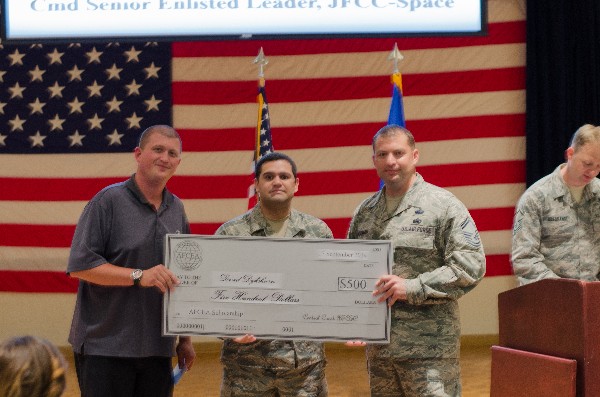 In September, Simmons (l) and Senior Master Sgt. Hackman present a science, technology, engineering and mathematics scholarship to Senior Airman David Dykshoorn, USAF.