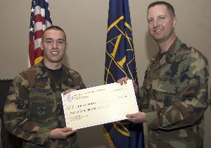 Lt. Col. John Gullet, USAF (r), awards a $250 Enlisted Grant to Airman Jonathan Fernandez, USAF (l), during the February chapter luncheon.