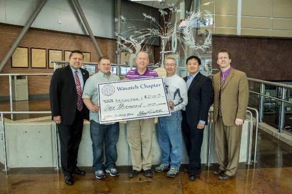 In May, (l-r) Ed Drollette, chapter president (far l) awards the STEM Science Teaching Tools Grant to Box Elder High School STEM teacher Eric Thorson, Principal Gary Allen, and STEM teacher Nolin Crook. Sammy Fan, vice president of finance, and Dr. Tim Martin, RVP regional vice president are please to present as well.