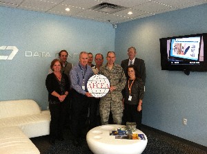 Lt. Col. Steve Bailey, USAF (r), chapter president, joins event attendees to present Dave Jenkins, vice president of marketing operations for C7 Data Centers, with a chapter coin in September.