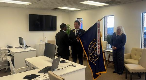 In October, Tim Martin, outgoing chapter president, passes the chapter flag to Murray, incoming chapter president.