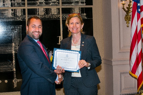 Chapter President Lisa Newell congratulates May AFCEAN of the Month Rob Cordray.