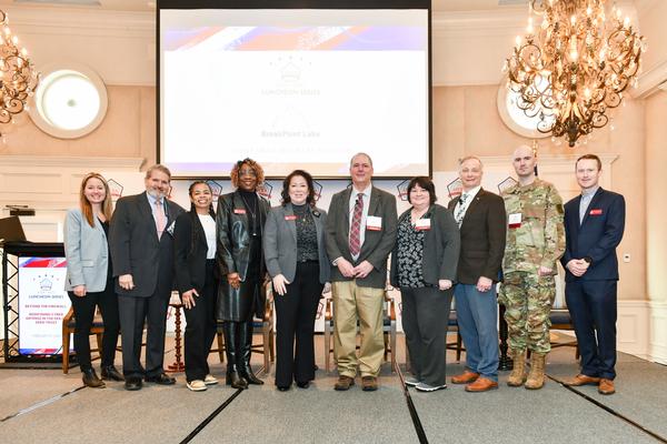 (l-r) Shaleen Braley, chapter vice president of programs, poses for a photo with Randy Resnick, senior advisor for the Zero Trust Office at the Department of Defense (DoD) Chief Information Officer (CIO); Lauren Williams, moderator; Thelma Baker and Indira Donegan, board members; Robert Mawhinney, Kama Stone, Daryl Haegley and CW4 Ben Koontz, panelists; and Donald Murphy, chapter board member.