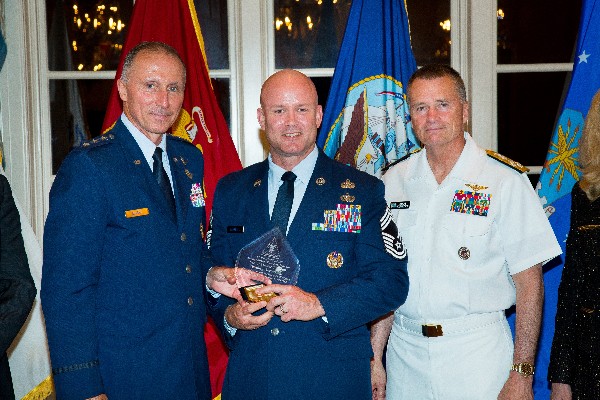Lt. Gen. William J. Bender, USAF (l), chief, Information Dominance and chief information officer, Office of the Secretary of the Air Force, with Adm. Winnefeld (r), present the Spring Military IT Leadership Award to an Air Force official accepting on behalf of Senior Master Sgt. Harold Terrance, USAF. 