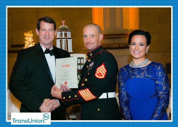 Chapter President Tim Sloms (l) presents a certificate to a  Toys for Tots representative at the December event.