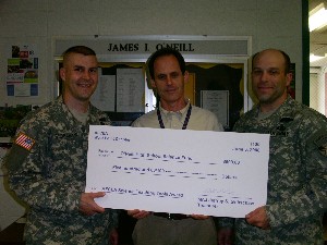 Maj. Gribschaw (l) and Maj. Newtson (r) presented Michael Mallon, O'Neill High School science program coordinator, with a check from the science fund on June 5.