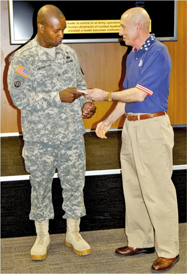 H.S. Schmidt, chapter president, presents guest speaker Brig. Gen. Bruce Crawford, USA, 5th Signal commander, with a token of appreciation at the April meeting.