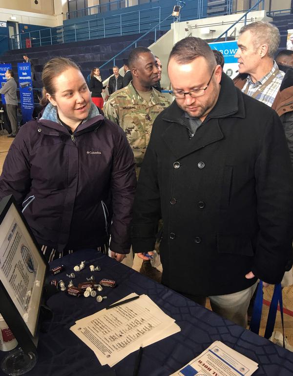 Cyndy Duscio, vice president of women's outreach, talks with Ryan Mayer from United States Army Europe (USAREUR G-6) about membership at the February event. Photo by Dawn N. Sverak.