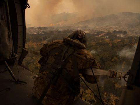 U.S. Army Sgt. Anthony Orduno, a UH-60 Black Hawk helicopter crew chief with Bravo Company, 1st Battalion, 140th Aviation Regiment in California, battles the Thomas Fire in Ventura in 2017. U.S. Air National Guard photo by Senior Airman Crystal Housman
