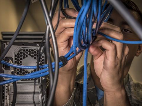 Air Force Airman 1st Class Zachary Brown configures a network switch at the 179th Airlift Wing in Mansfield, Ohio, January 26, 2018. The Defense Information Systems Agency, which provides information technology solutions for the Defense Department, has released its 2023 Contracts Guide. Photo by: Air Force Tech Sgt. Joe Harwood