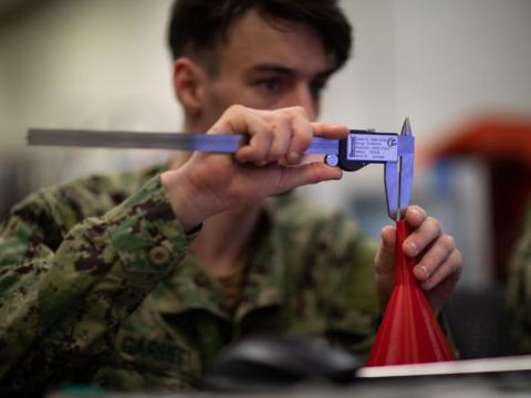 Fireman Dalton Garret, assigned to the USS Bataan Engineering Department, produces a computer-aided draft for a three-dimensional printing project. The USS Bataan sent five engineering department sailors to a 3D-printing course to manufacture objects using newly installed additive manufacturing equipment onboard the vessel. Credit: Mass Communication Specialist 2nd Class Matthew F. Brown, U.S. Navy