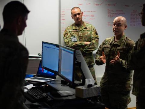 U.S. Air Force Tech. Sgt. Daniel Bowser, 1st Combat Communications Squadron mission defense team (MDT) section chief assigned to Ramstein Air Base, Germany, discusses the integrity of data with other warfighters during the so-called Tacet Venari exercise at Ramstein last May. The Air Force is going to continue its MDT construct. U.S. Air Force photo by Airman 1st Class Jared Lovett