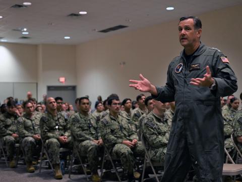 Navy Vice Adm. Craig Clapperton, commander, U.S. Fleet Cyber Command/U.S. 10th Fleet, speaks to sailors and civilians assigned to Navy Cyber Defense Operations Command during a Meritorious Unit Commendation award presentation in Suffolk, Virginia on August 17, 2023. U.S Navy Photo by Lt. j.g. Daniel Ambrose