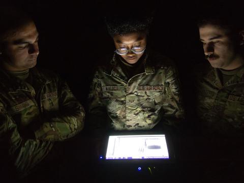 436th Civil Engineer Squadron Explosive Ordnance Disposal technicians (l-r) Senior Airman Kevin Sinning, Airman 1st Class Ariana Nalica and Senior Airman James Verrelli, look at the X-ray of an improvised explosive device taken during a training session at Dover Air Force Base, Delaware, in October 2023. A portable X-ray device wirelessly sends the image to a display tablet for viewing and analysis.   U.S. Air Force photo by Roland Balik