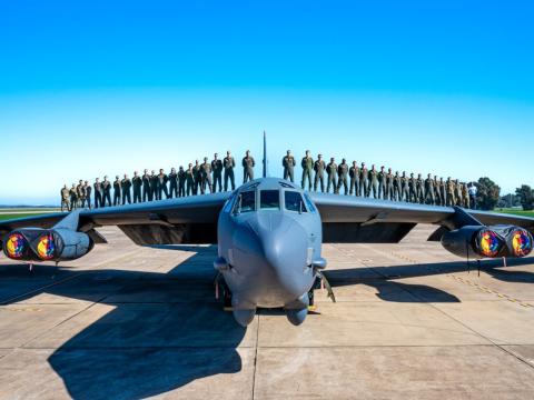 Pilots stand on top of the Air Force’s B-52H aircraft in an updated photo. The service’s Air Force Life Cycle Management Center (LCMC) is responsible for the B-52H Commercial Engine Replacement Program to keep the aircraft in service. The LCMC’s Program Executive Officer for Command, Control, Communications, Intelligence, and Networks provides the underpinning of networks and cyber to support the service’s operations. Credit: U.S. Air Force